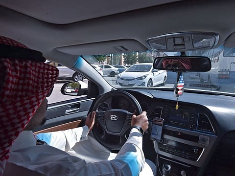 Saudi driver Hussain drives his car as he starts his day working for Uber, in the capital Riyadh, on January 20.