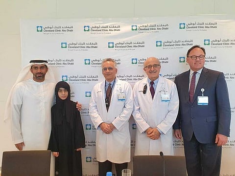 Alia (2nd from left) and her father (left) with Dr Arif Khan (3rd from left), paediatric ophthalmologist and ocular geneticist at Cleveland Clinic Abu Dhabi, and other hospital doctors at a press conference in Abu Dhabi. Alia and her sister, Hessa, were the first to receive gene therapy in the UAE. Picture by Samihah Zaman,