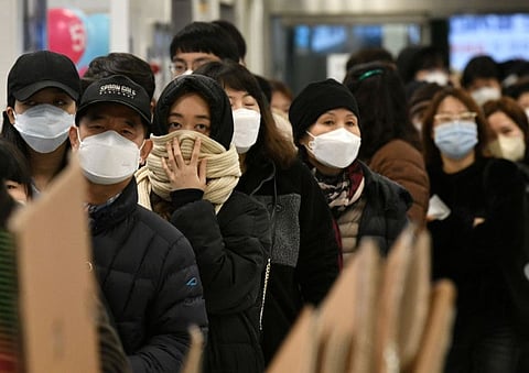 People wait in a line to buy face masks at a retail store in the southeastern city of Daegu in South Korea