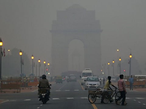 Traffic makes its way through haze mainly caused by air pollution in Delhi.