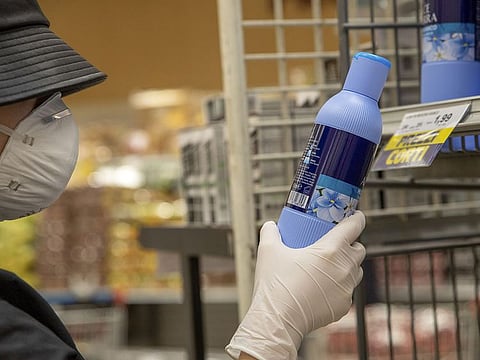 Photo for illustrative purposes only: A customer wearing a protective face mask and gloves reads a cleaning product label in a grocery store in Milan, Italy, on Tuesday, Feb. 25, 2020.