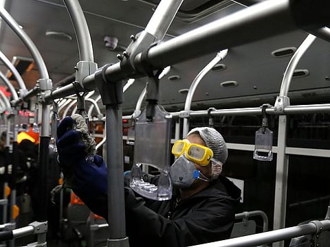 A Tehran Municipality worker cleans a bus to avoid the spread of the COVID-19 illness on February 26, 2020.