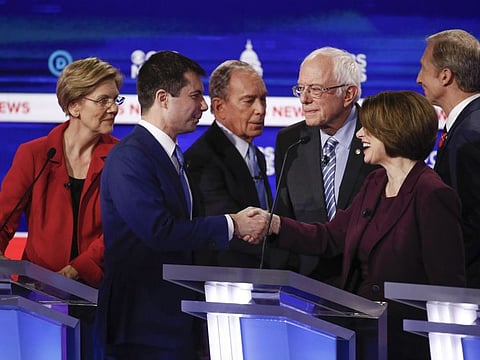 From left, Democratic presidential candidates, Sen. Elizabeth Warren, former South Bend Mayor Pete Buttigieg, former New York City Mayor Mike Bloomberg, Sen. Bernie Sanders,  Sen. Amy Klobuchar, and businessman Tom Steyer, greet one another on stage at the end of the Democratic presidential primary debate at the Gaillard Center on Tuesday in Charleston, South Carolina, co-hosted by CBS News and the Congressional Black Caucus Institute.