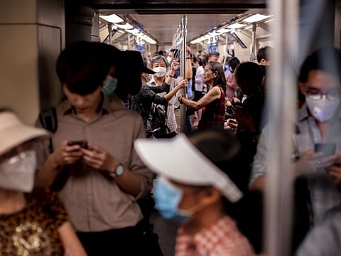 Commuters wear face masks to protect themselves from the new virus in Bangkok on Wednesday.