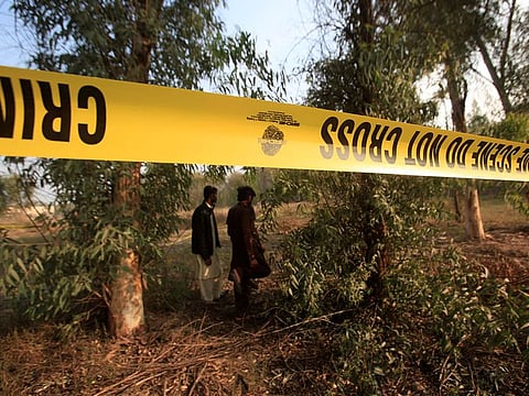 Men walk near a cordoned area, after remains of a teenager, who had been missing for two days, were found in the lions' enclosure at a safari park in Lahore, Pakistan February 26, 2020.