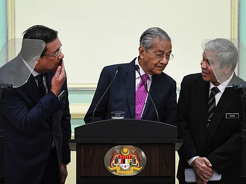 Malaysia's interim Prime Minister Mahathir Mohamad (C) attends a press conference after unveiling an economic stimulus plan aimed at combating the impact of the COVID-19 novel coronavirus at the Prime Minister's Office in Putrajaya on February 27, 2020.