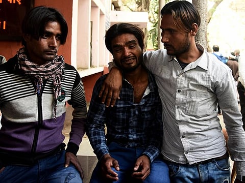 Relatives of victims of the riots mourn at a hospital in New Delhi on Thursday.