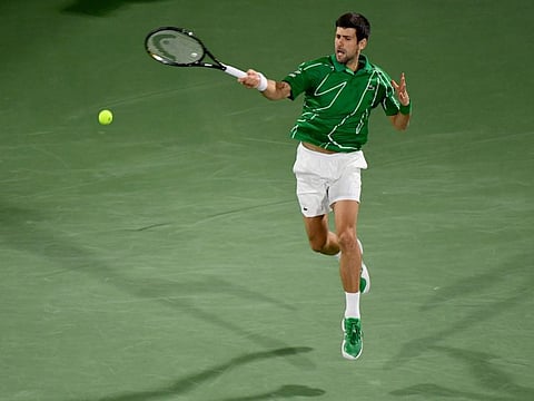 Novak Djokovic returns the ball to Karen Khachanov during their quarter-final match on Thursday.