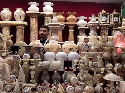 A man sells wares made of onyx marble in Pakistan’s pavilion.