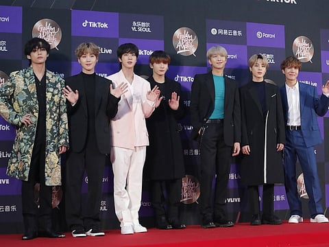 Members of South Korean K-Pop group BTS pose for photos during the Golden Disk Awards in Seoul, South Korea, Sunday, Jan. 5, 2020.