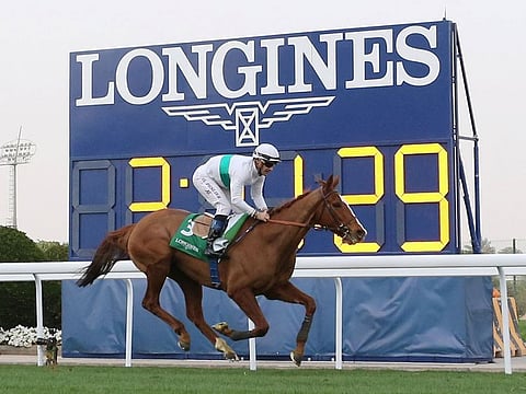 Olivier Peslier wins the Longines Turf Cup on Call The Wind.