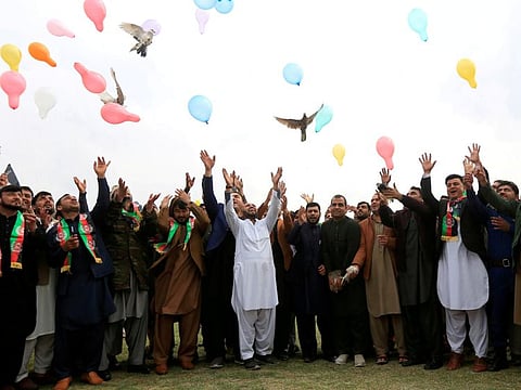 Afghan men celebrate in anticipation of the US-Taliban agreement to allow a US troop reduction and a permanent ceasefire, in Jalalabad, Afghanistan on Friday.