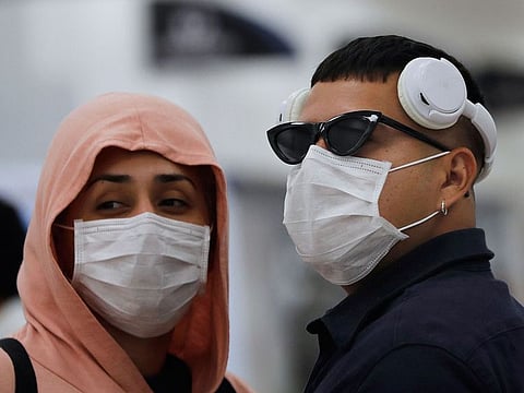 A couple wears protective masks as a precaution against the spread of the new coronavirus at the airport in Mexico City, Friday, Feb. 28, 2020. Mexico assistant health secretary announced Friday that the country now has confirmed cases of the COVID-19 virus.