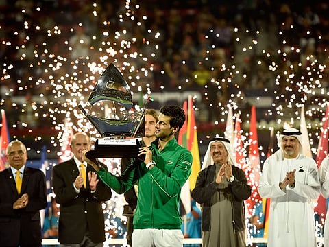 Novak Djokovic with the winner's trophy at Dubai Duty Free Tennis Championship in 2020.
