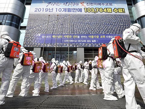 South Korean army soldiers wearing protective suits spray disinfectant to prevent the spread of the coronavirus in front of a branch of the Shincheonji Church of Jesus  in Daegu, South Korea, March 1.