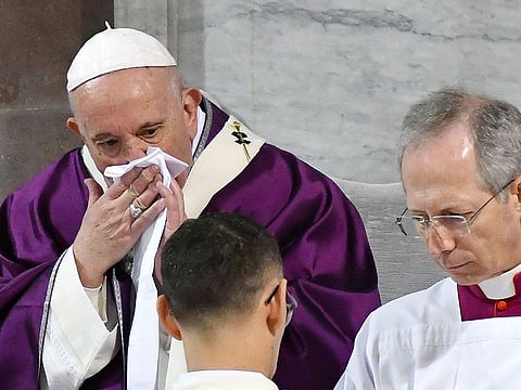 Pope Francis wipes his nose during the Ash Wednesday mass which opens Lent, the forty-day period of abstinence and deprivation for Christians before Holy Week and Easter, on February 26, 2020, at the Santa Sabina church in Rome. Pope Francis postponed his official appointments on February 28 and was working from home, the Vatican said, a day after cancelling a scheduled appearance at mass because of "a mild ailment". Francis, 83, had appeared earlier in the week to be suffering from a cold. He was seen blowing his nose and coughing during the Ash Wednesday service, and his voice sounded hoarse.