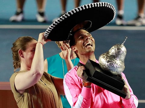 Rafael Nadal celebrates with the winner's trophy and the traditional Mexican hat after the final in Acapulco on Saturday.
