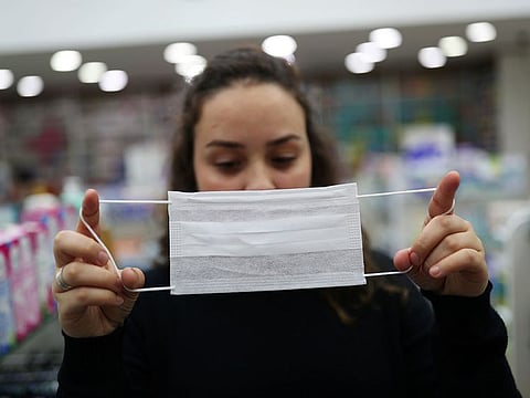 A vendor displays a protective mask at a pharmacy, after the second case of coronavirus in Sao Paulo was confirmed, at Guarulhos International Airport in Guarulhos, Sao Paulo state, Brazil, February 29, 2020.