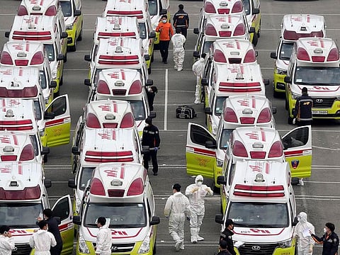 Ambulances are parked to transport possible coronavirus patients in Daegu, South Korea, Sunday, March 1, 2020.