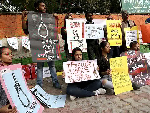 Members of the People’s Union for Democratic Rights hold placards during a protest, opposing the death penalty of the four convicts in the Nirbhaya case, in New Delhi last month.