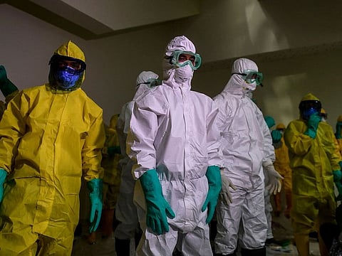 Officials wearing protective suits prepare to check Indonesians who were evacuated from the Diamond Princess cruise ship, before they are transported to Sebaru island for observation, at Kertajati International airport in Majalengka, West Java province, Indonesia, March 1, 2020 in this photo taken by Antara Foto. Picture taken March 1, 2020.