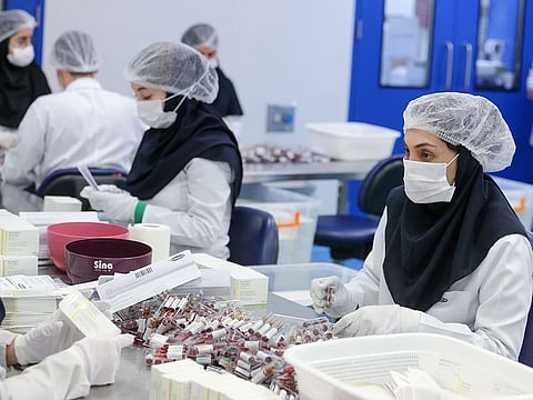 Pharmaceutical factory workers package vitamin and mineral supplement ampoules at the Actoverco plant in Karaj, about 40km west of Tehran.