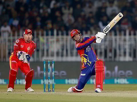 Karachi Kings batsman Alex Hales plays a shot while Islamabad United wicketkeeper Luke Ronchi watches during the Pakistan Super League T20 cricket match against Islamabad United, in Rawalpindi, Pakistan, on March 1, 2020. The final, which has been suspended due to COVID-19, will be played on November 17, 2020.