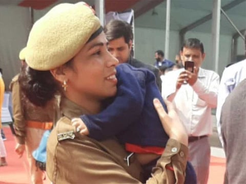 Constable Priti Rani with her infant son in her arms at Yogi Adityanath's event in Noida.
