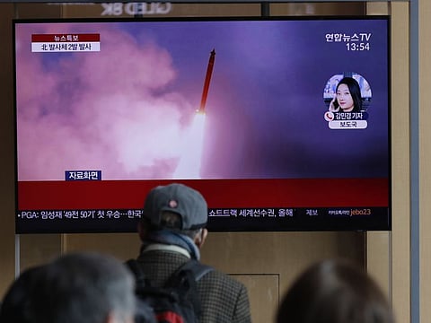 South Koreans watch a TV screen showing a news programme reporting about North Korea's firing projectiles with a file image at the Seoul Railway Station in Seoul, South Korea, on Monday. North Korea fired two unidentified projectiles into its eastern sea on Monday as it begins to resume weapons demonstrations after a months-long hiatus.
