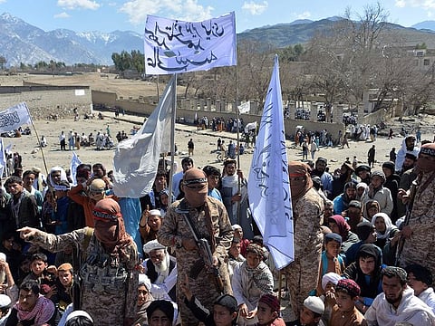 Afghan Taliban militants and villagers attend a gathering as they celebrate the peace deal and their victory in the Afghan conflict on US in Afghanistan, in Alingar district of Laghman Province on March 2, 2020.