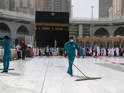 Cleaners wear protective face masks, following the outbreak of the coronavirus, as they swipe the floor at the Ka'aba in the Grand Mosque in the holy city of Mecca on Tuesday.