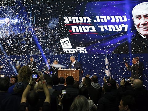 Confetti falls as Benjamin Netanyahu, Israel's prime minister, center right, and his wife Sara Netanyahu stand on stage at the Likud party headquarters in Tel Aviv early on Tuesday.