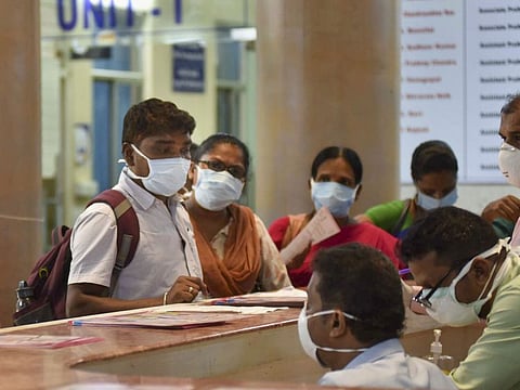 Visitors wear protective masks in the wake of the novel coronavirus outbreak, at Government Gandhi Hospital in Hyderabad on Tuesday. India has issued a revised travel advisory following more cases of the virus in the country.