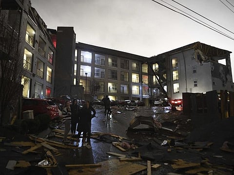 Debris is scattered across the parking lot of a damaged apartment building after a tornado hit Nashville in the early morning hours of Tuesday.
