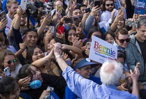 Democratic Presidential candidate Bernie Sanders greets supporters after speaking at Valley High School in Santa Ana, California, on February 21, 2020. The generational divide among Latino politicians in Southern California over Bernie Sanders; younger ones are endorsing him in droves, while older, more prominent ones haven't.