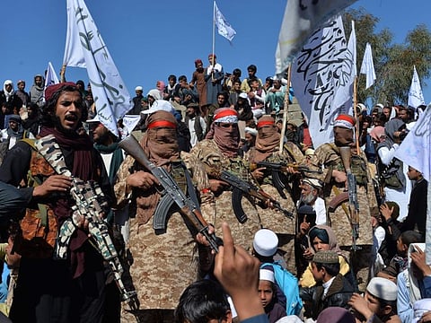 Afghan Taliban militants and villagers attend a gathering as they celebrate the peace deal and their victory in the Afghan conflict on US in Afghanistan, in Alingar district of Laghman Province on March 2.