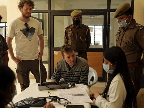 Indian doctors check foreign tourists at a coronavirus screening camp in Lakhanpur, 92km from Jammu, on Wednesday.