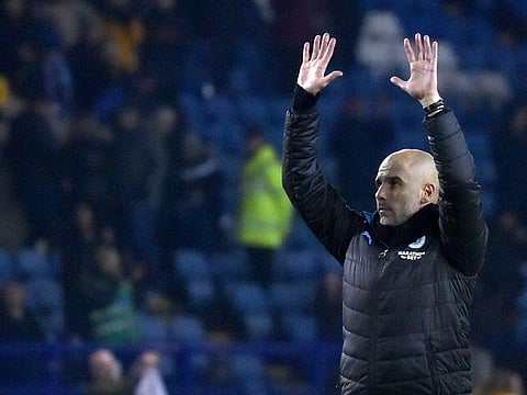 Manchester City's head coach Pep Guardiola celebrates at the end of the match.