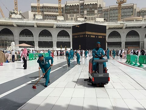 Workers clean the Grand Mosque, during Umrah, in Makkah, Saudi Arabia, Monday, March 2, 2020.