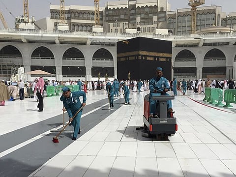 Workers clean the Grand Mosque, in Mecca