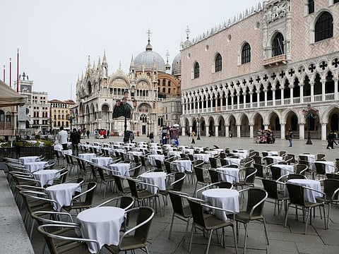 Empty tables are pictured outside a restaurant at St Mark's Square, which is usually full of tourists, after Italy's government adopted a decree with emergency new measures to contain the coronavirus, in Venice, Italy, on Thursday.