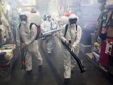 Firefighters disinfect a traditional shopping center to help prevent the spread of the new coronavirus in northern Tehran, Iran, Friday, March, 6, 2020.