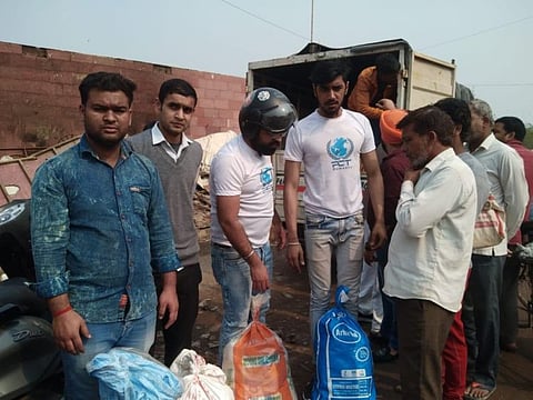 Volunteers of PCT Humanity Trust distribute relief supplies to violence-hit residents in Delhi