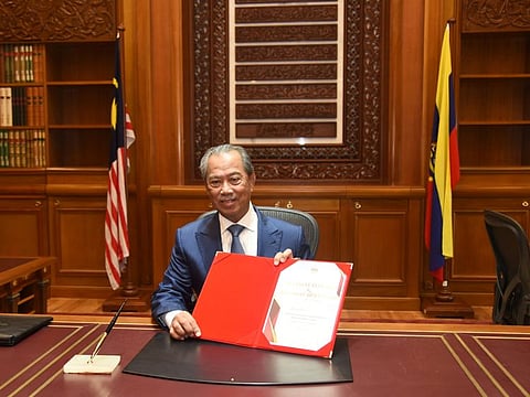 Malaysia’s Prime Minister Muhyiddin Yassin poses for a picture on his first day at the prime minister's office in Putrajaya, Malaysia, March 2, 2020.