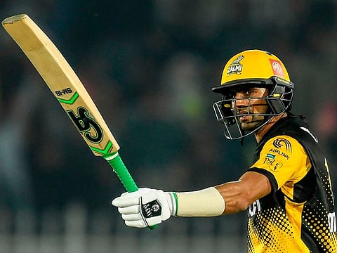 Peshawar Zalmi's Shoaib Malik celebrates after scoring a half-century against Quetta Gladiators at the Rawalpindi Cricket Stadium