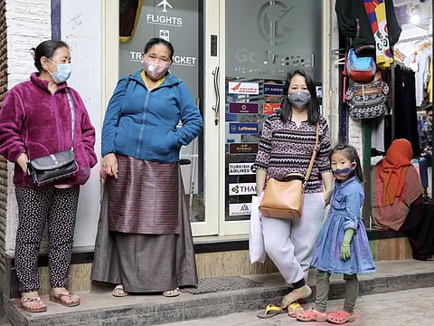 People wearing protective face masks following an outbreak of the coronavirus in India, at Majnu Ka Tilla Market in New Delhi on Friday.