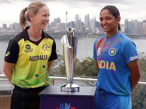 Meg Lanning (left) Harmanpreet Kaur, captains of the two finalist teams Australia and India, pose with the winners' trophy ahead of the ICC T20 Women's World Cup final in Meblbourne on Sunday.