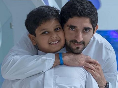 Sheikh Hamdan Bin Mohammad Bin Rashid Al Maktoum with cancer patient Abdullah Hussain