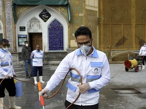 Workers disinfect a Shiite shrine to help prevent the spread of the new coronavirus in Shahr-e-Ray, south of Tehran, March 7.