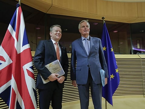 European Union chief Brexit negotiator Michel Barnier, right, speaks with the British Prime Minister's Europe adviser David Frost during the start of the first round of post -Brexit trade talks between the EU and the UK, at EU headquarters in Brussels